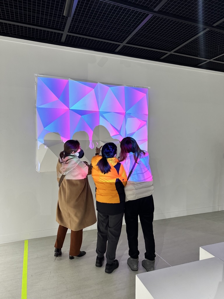 Visitors engaging with the interactive projection